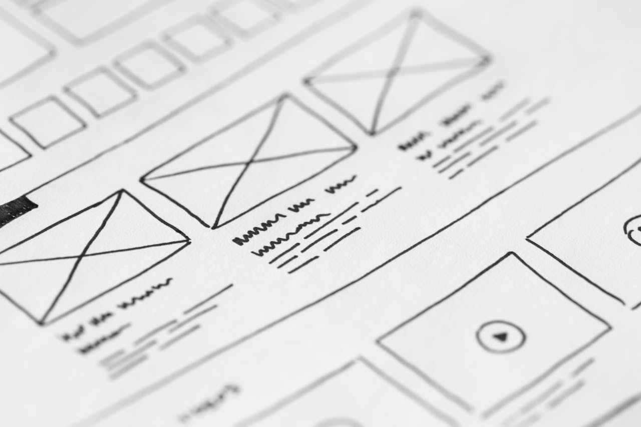 about-02 Detailed close-up of a hand-drawn wireframe design on paper for a UX project.